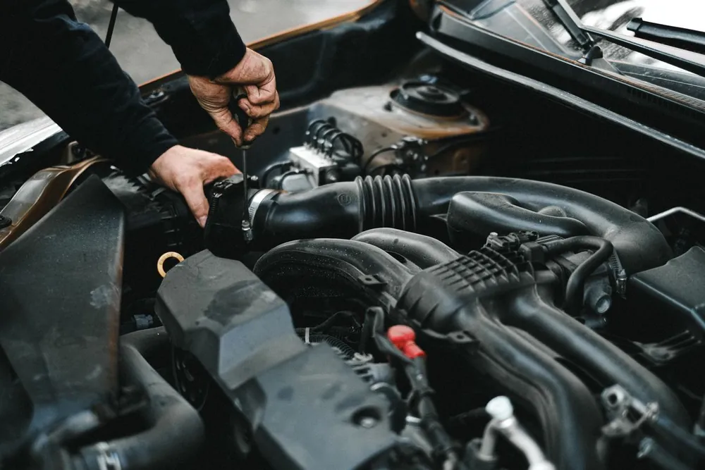 Illustrative stock photograph of hands working on an engine